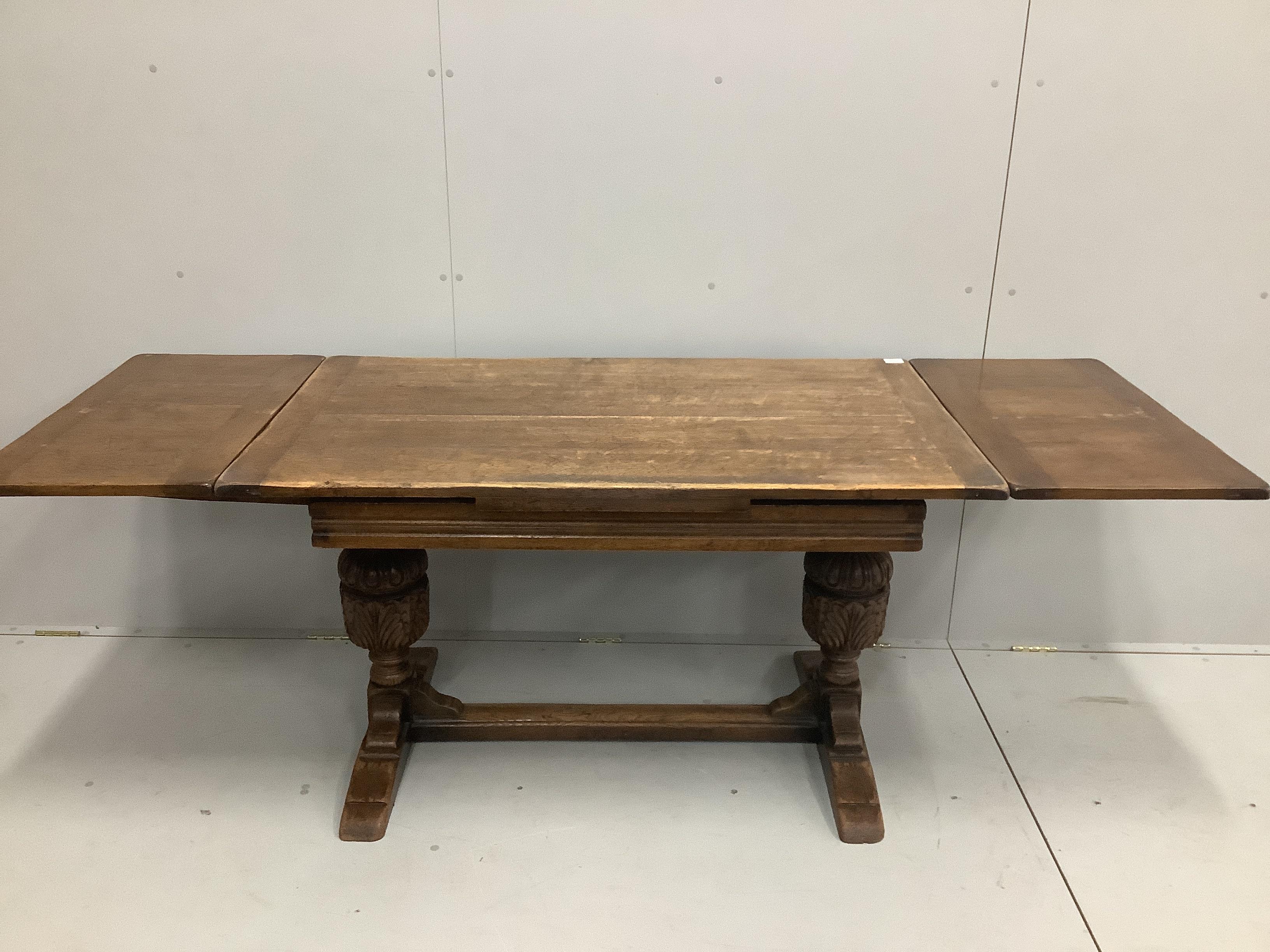 An 18th century style rectangular oak draw leaf dining table, length 210cm extended, width 77cm, height 75cm together with six oak dining chairs, two with arms